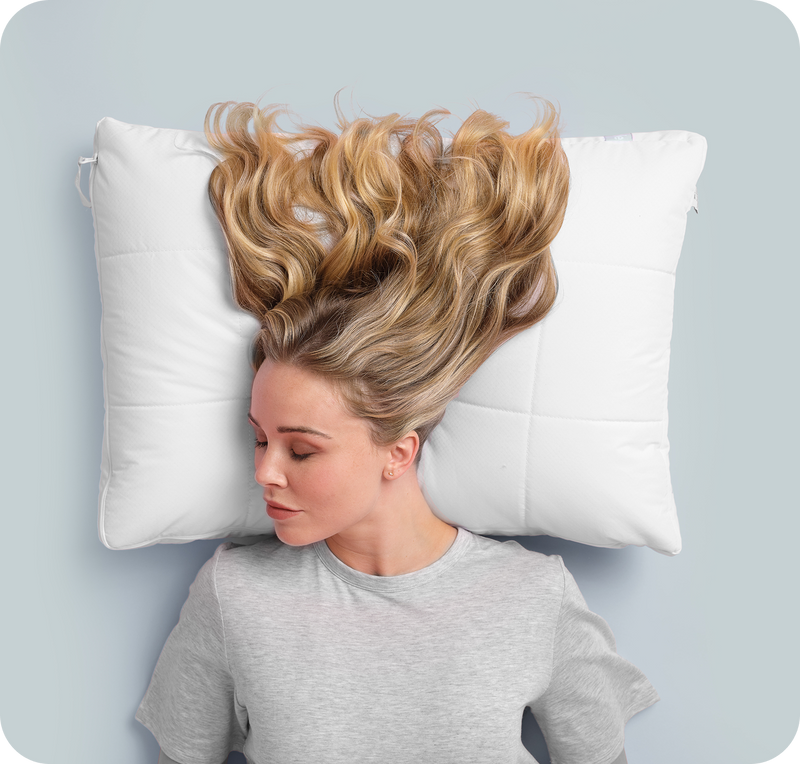 Woman sleeping comfortably on Nuzzle Pillow